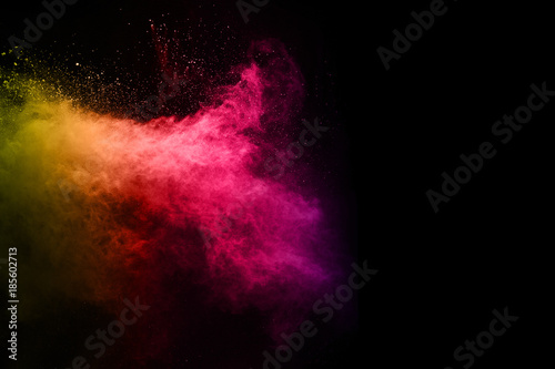 abstract powder splatted background. Colorful powder explosion on black background. Colored cloud. Colorful dust explode. Paint Holi.