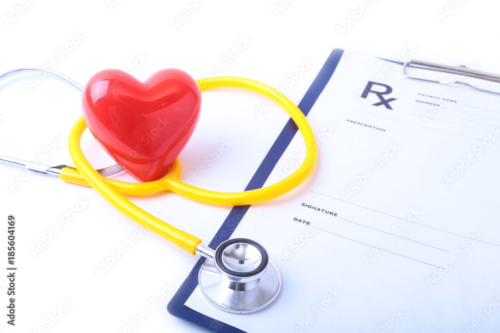 Heart with a medical stethoscope, isolated on wooden background Heart with a medical stethoscope, isolated on wooden background