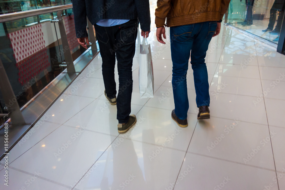 Fototapeta premium low section view of two men shopping