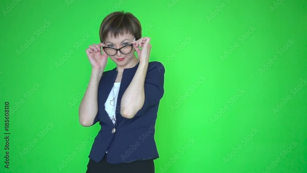 Young business woman or teacher in business clothes and wearing glasses, chroma key green screen background