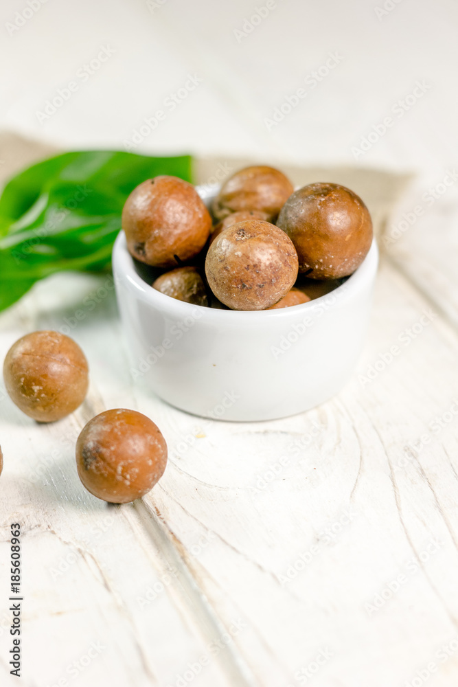 Nice macadamia nuts on white wooden table. Nice macadamia nuts on white wooden table.