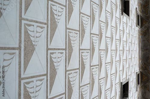 Detail of traditional sgraffito on the facade of a building in town of Cesky Krumlov, Czech Republic. Brown and white design made from concrete and plaster in an intricate design on exterior walls.