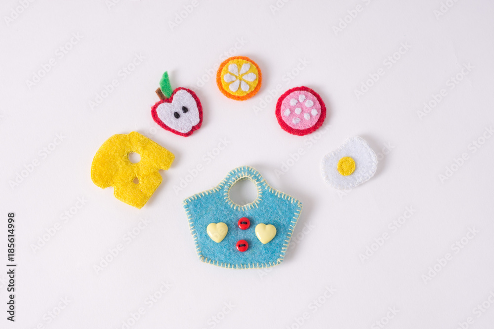 Toys in the form of food and fruits hand made of felt on a white background. Hand sewing