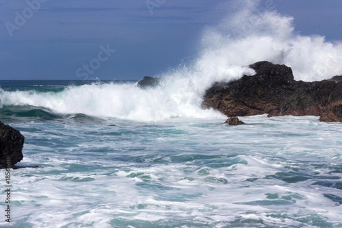 Massive implacable waves of the Pacific Ocean crash upon the unbreaking volcanic rock of Costa Rica's Playa San Janillo. photo