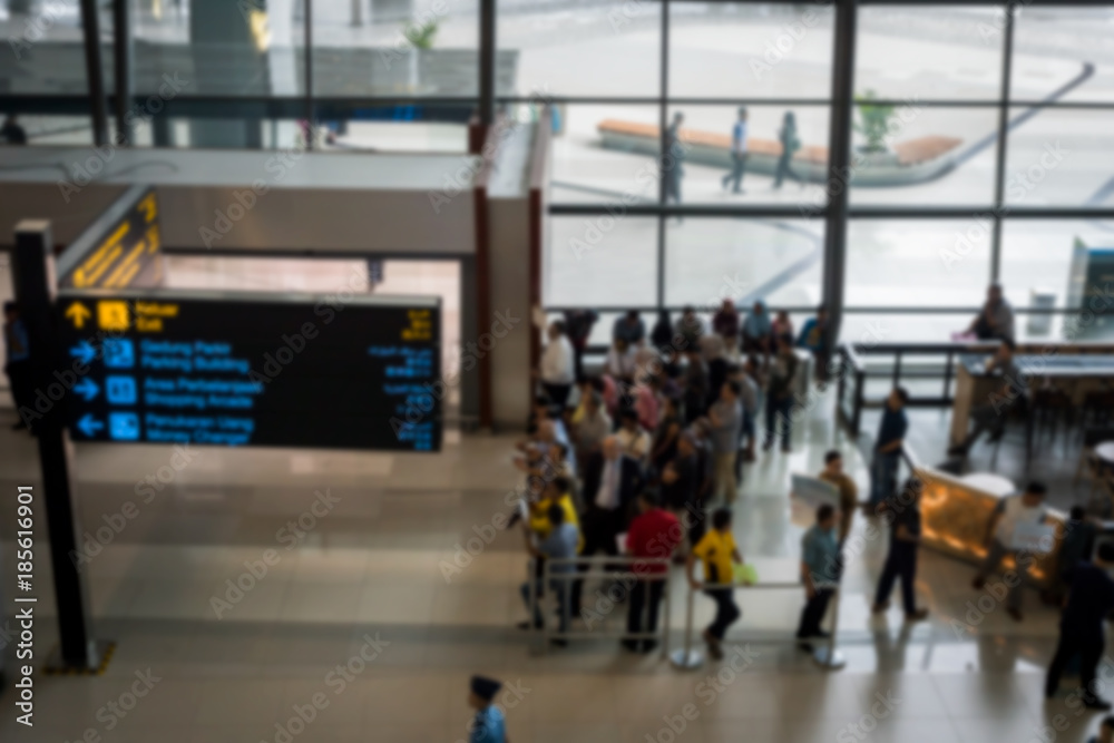 Fototapeta premium airport arrival area with people waiting - blurred abstract photo