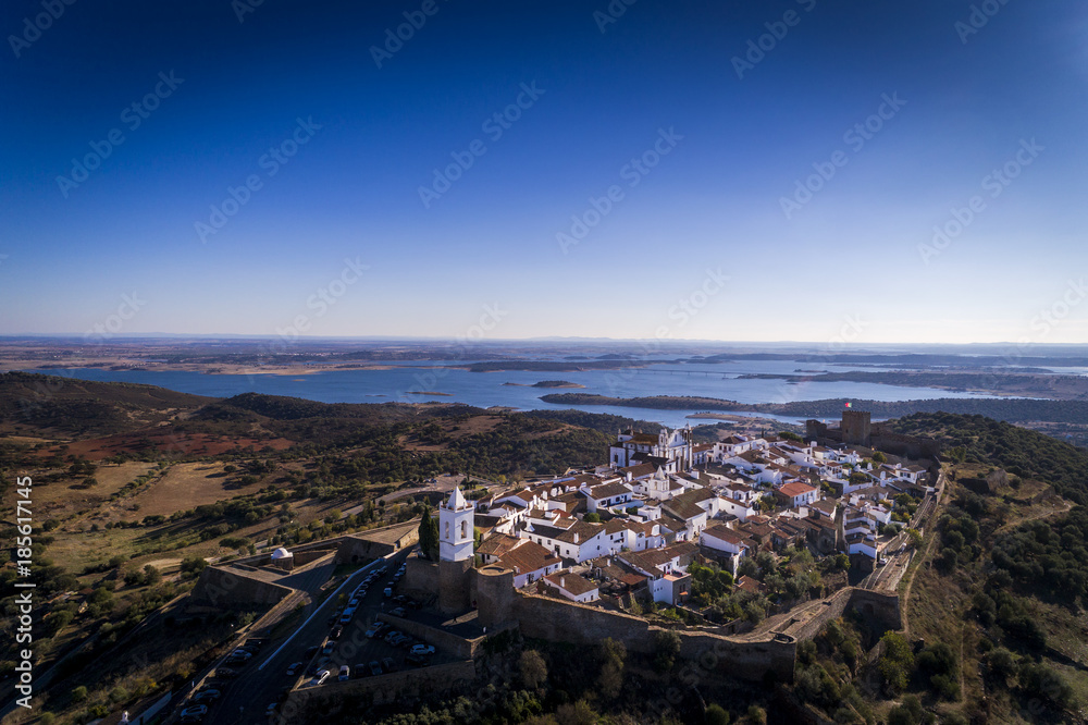 Fototapeta premium Aerial view of the historic village of Monsaraz in Alentejo with the Alqueva dam reservoir on the background; Concept for travel in Portugal and Alentejo