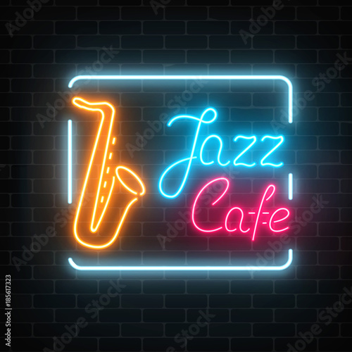 Neon jazz cafe and saxophone glowing sign on a dark brick wall background.