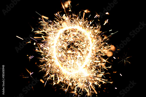 Letter  Q  made of sparklers isolated background.