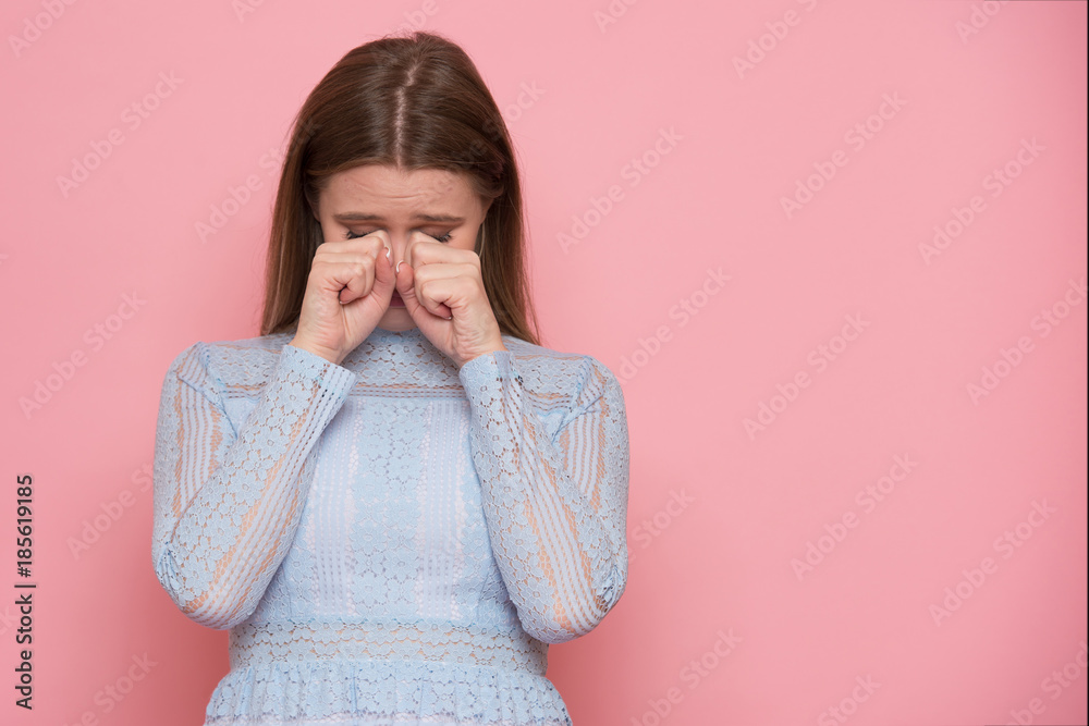 whimsical crying beautiful woman isolated on pink background whimsical crying beautiful woman isolated on pink background