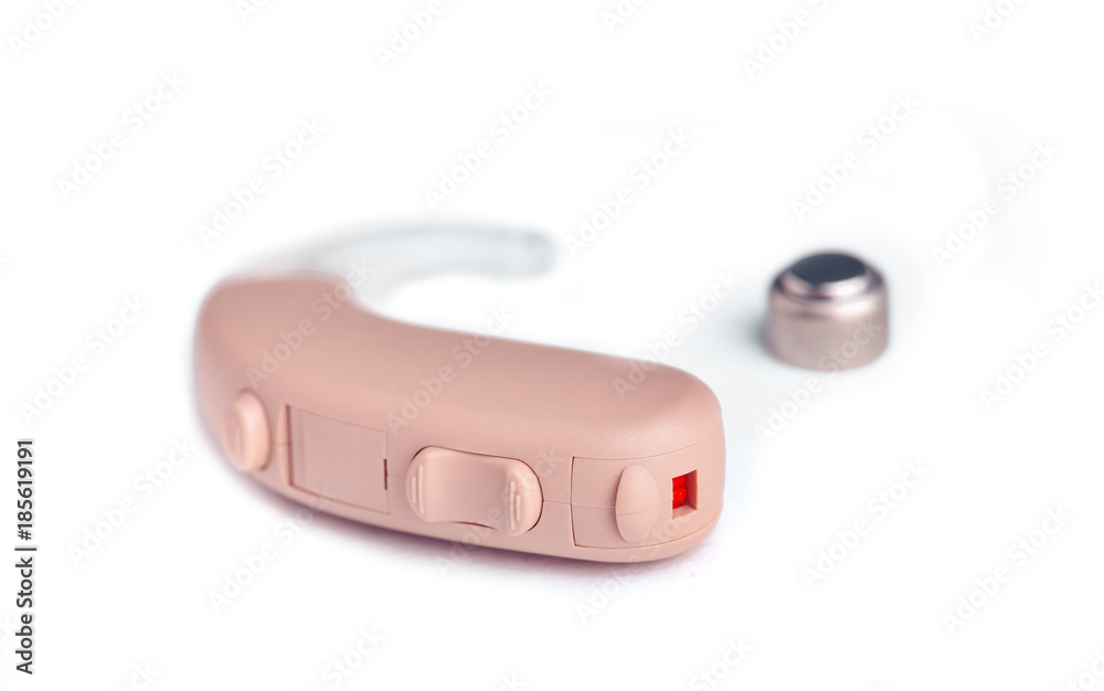 Hearing aid close up on white background with batteries Hearing aid close up on white background with batteries