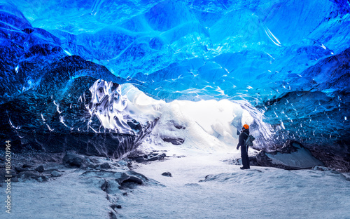 Traveler in ice cave