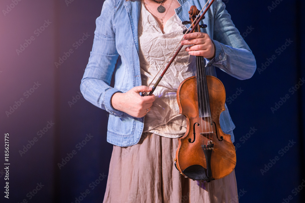 Fototapeta Women violinist with a violin and bow in hands