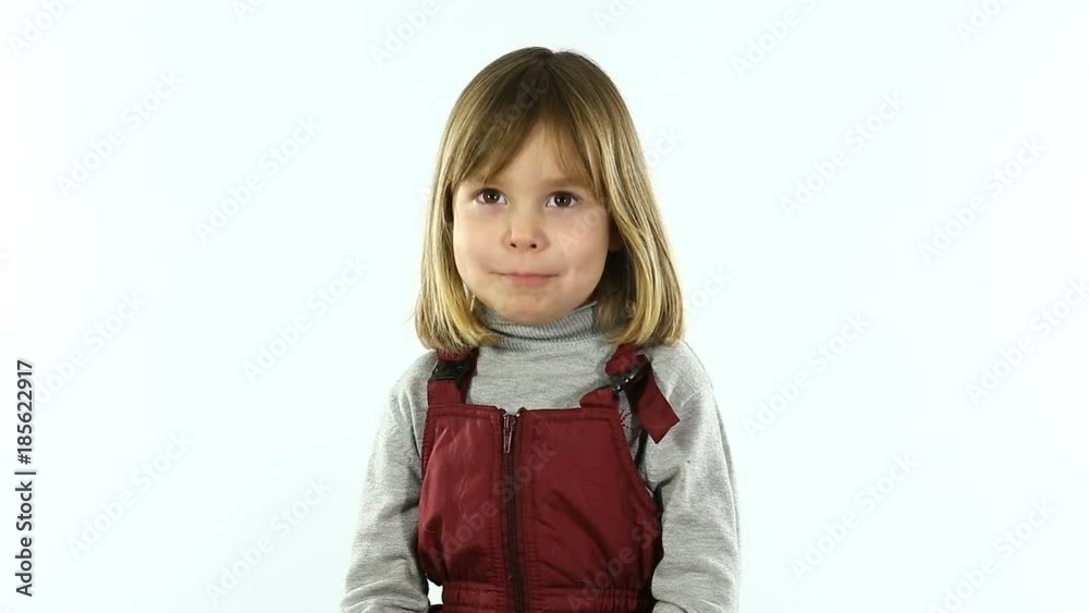 Studio, white background. A little girl of four or five, with blond hair, is photographed for a visa. A child of European appearance. Studio, white background. A little girl of four or five, with blond hair, is photographed for a visa. A child of European appearance.