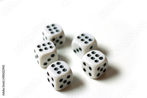 Five white dice on which there are six on the top, isolated