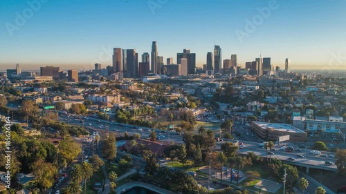 Cinematic urban aerial time lapse of downtown Los Angeles skyline with freeway traffic. photo