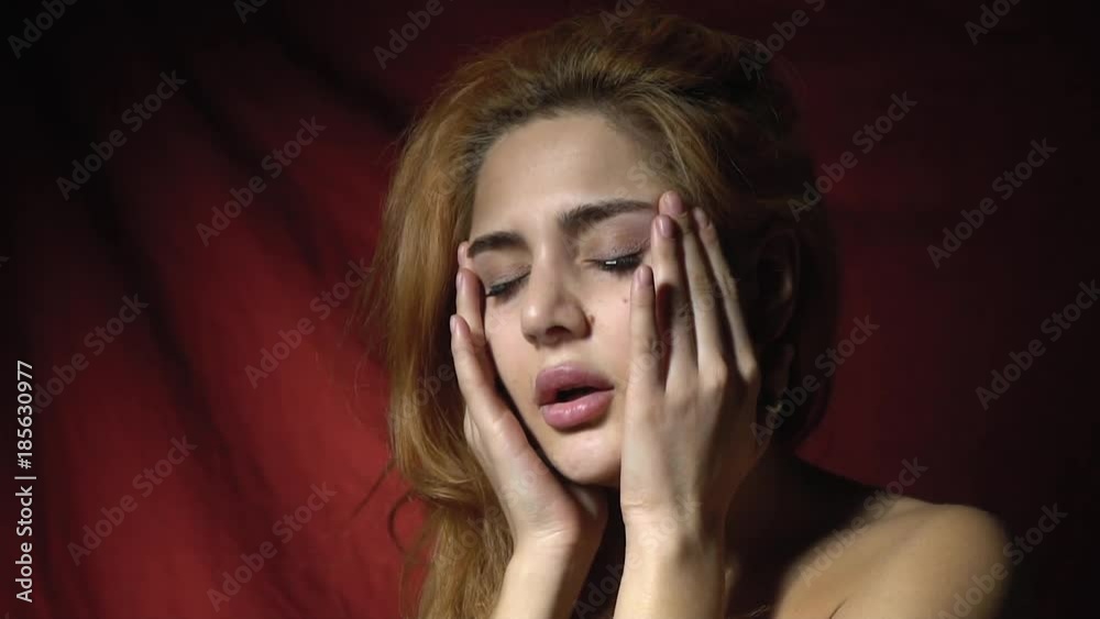 A beautiful woman massaging her head suffering from a headache A beautiful woman massaging her head suffering from a headache