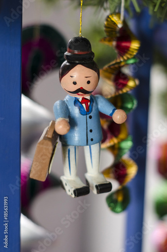 Figurine of a man with a hat and a suitcase as decoration for christmas tree