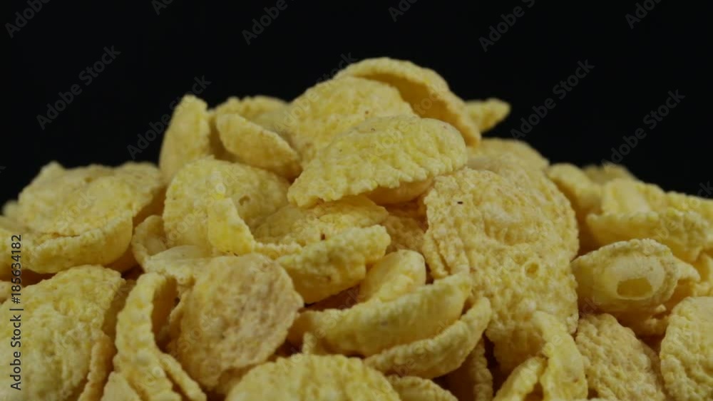 Rotating corn chips close up, macro crunchy corn chips for muesli background Rotating corn chips close up, macro crunchy corn chips for muesli background