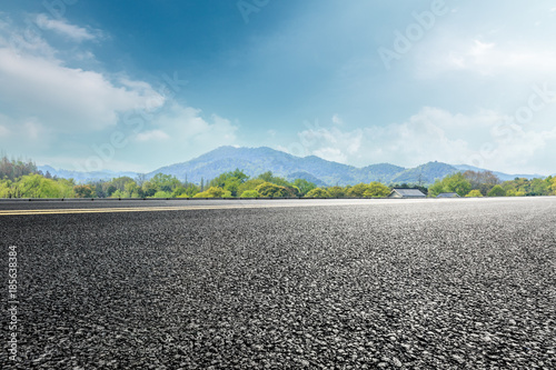 asphalt highway and green mountain nature landscape under blue sky © ABCDstock
