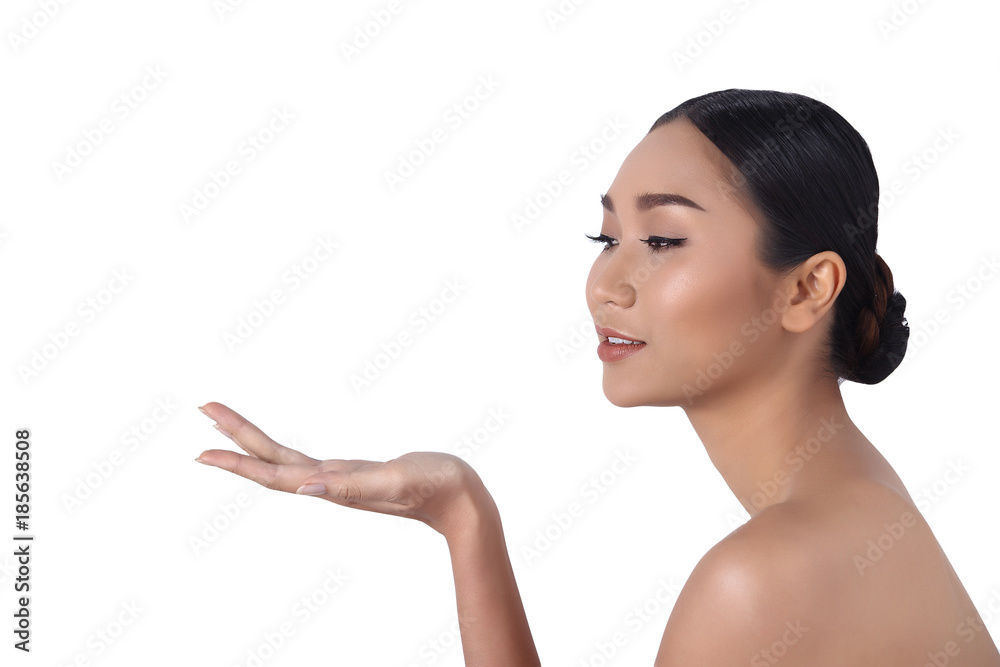 Tanned skin young fashion Asian woman model present showing empty copy space on her hand palm Tanned skin young fashion Asian woman model present showing empty copy space on her hand palm