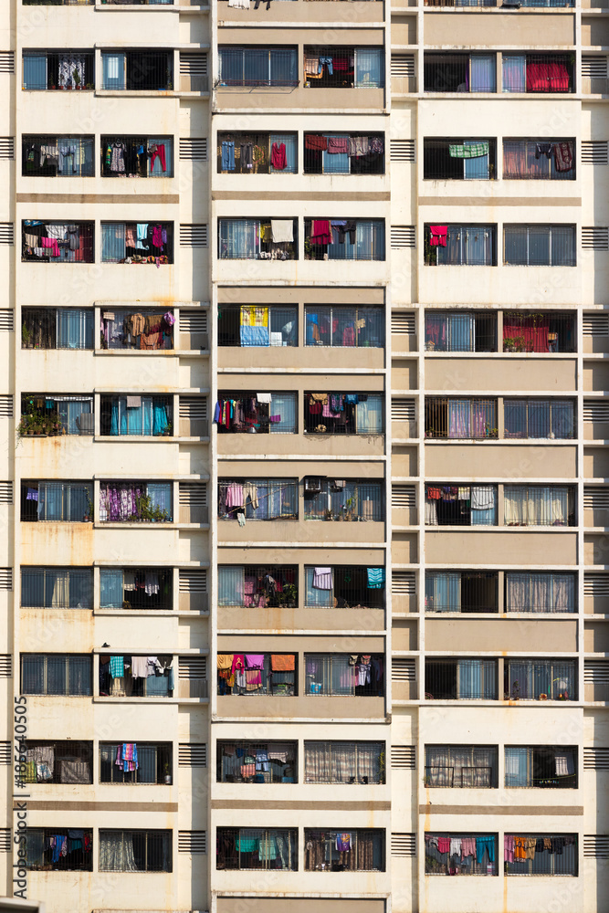 Section from the exterior of an residential building, all balconies full of laundry hanged, Mumbai, India