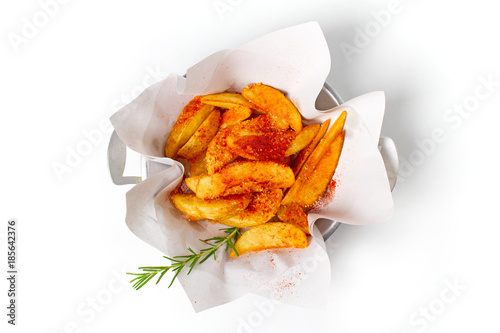 Fried potato sprinkled with paprika powder. photo