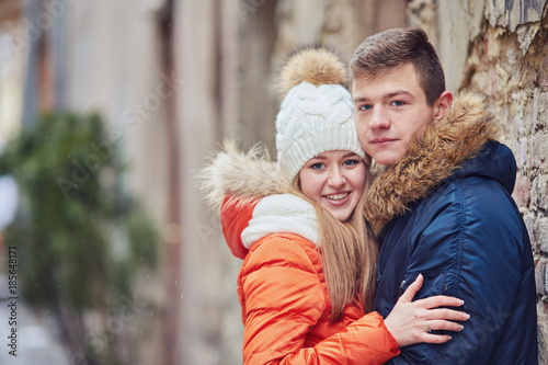 Young couple kissing at wintertime outdoors