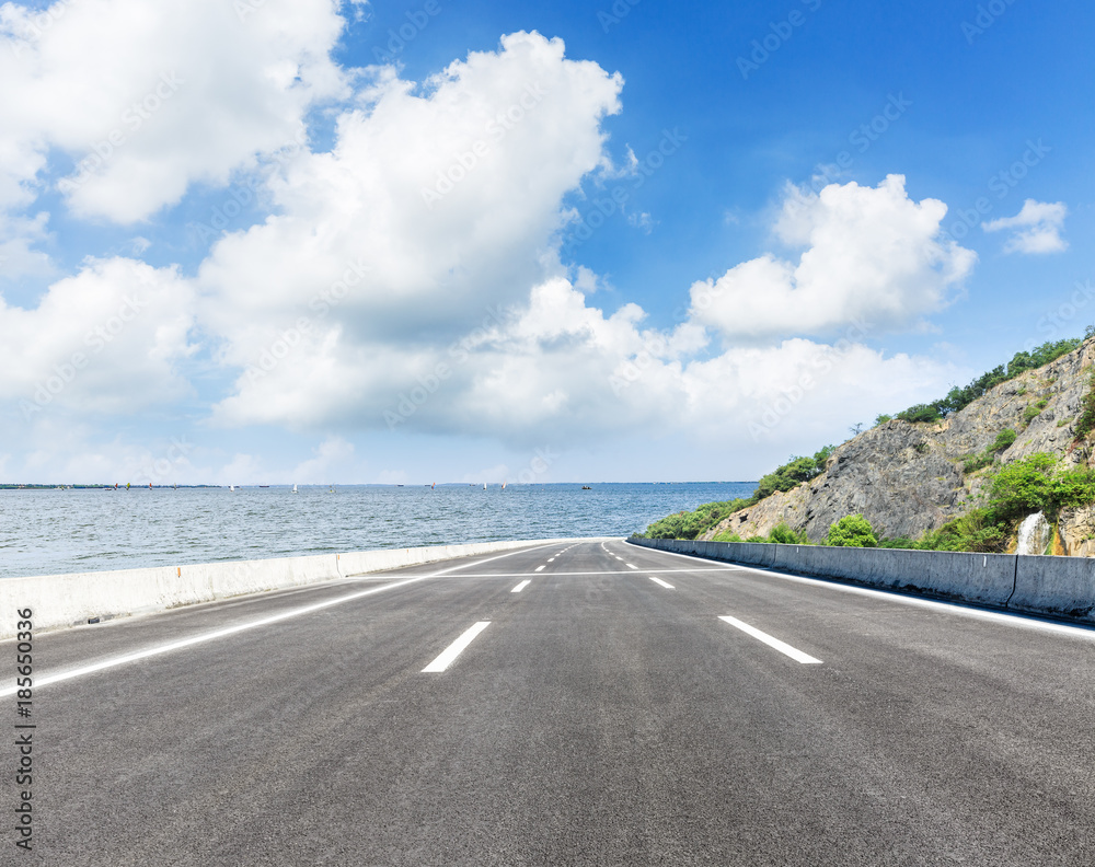 asphalt highway and mountain on the edge of the river asphalt highway and mountain on the edge of the river