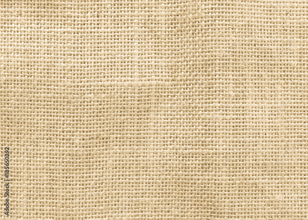 Jute hessian sackcloth woven burlap texture background in yellow beige cream color Jute hessian sackcloth woven burlap texture background in yellow beige cream color