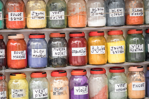Assortment of glass jars on shelves in herbalist shop on a traditional Moroccan market (souk) in Essaouira, Morocco