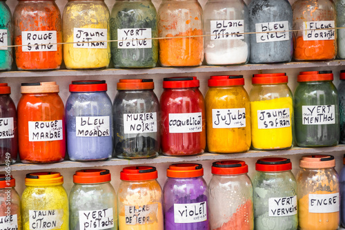 Assortment of glass jars on shelves in herbalist shop on a traditional Moroccan market (souk) in Essaouira, Morocco