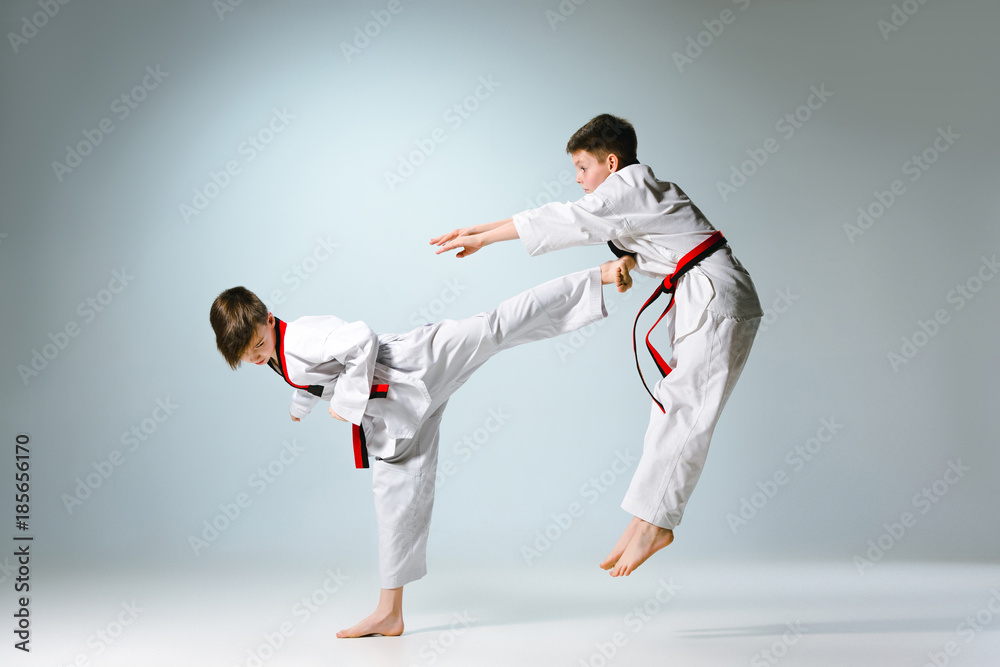 Studio shot of two of kids training karate martial arts Studio shot of two of kids training karate martial arts