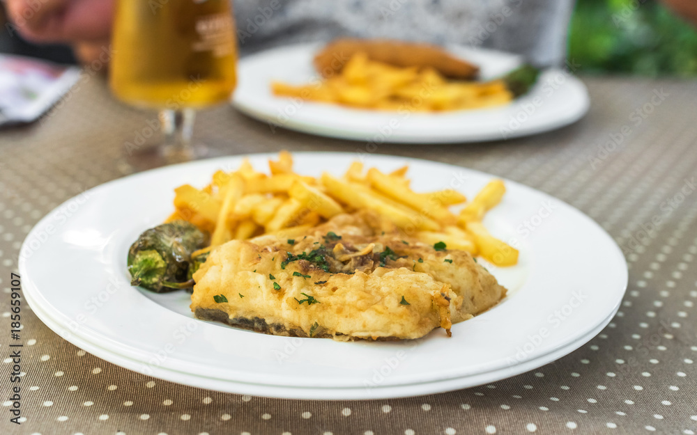 Fish with french fries on a plate, Siurana, Catalunya, Spain. Close-up. Fish with french fries on a plate, Siurana, Catalunya, Spain. Close-up.