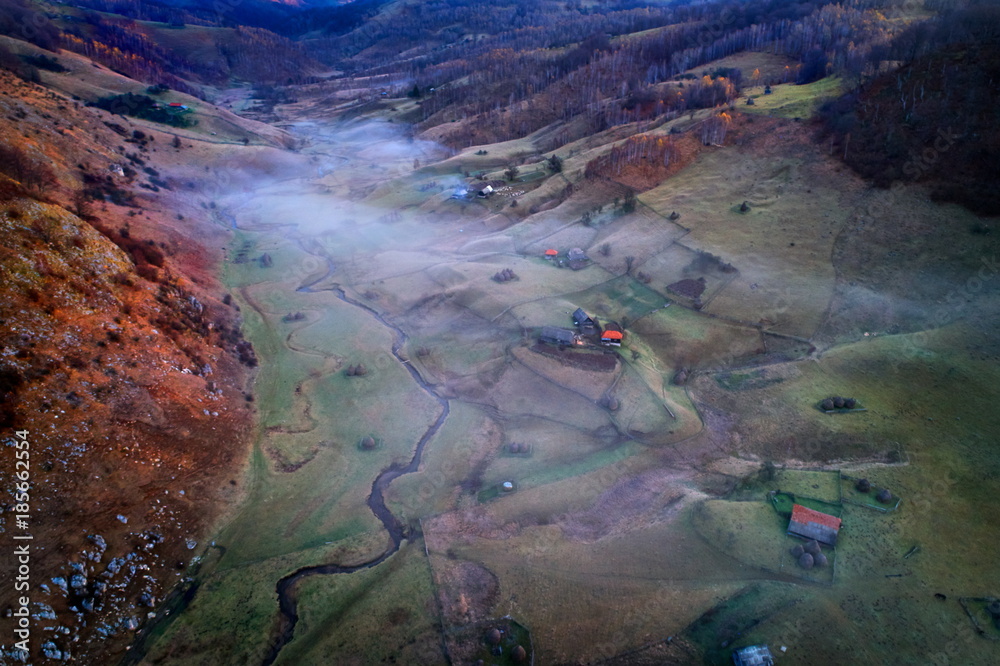 aerial view of mountain landscape with autumn morning fog at sunrise - Romania