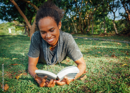 Fényképezés Beautiful young pacific islander student with afro hairstyle and book in her han