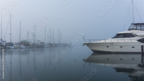 Moored boat on a cold misty morning photo