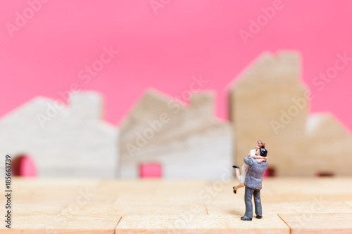 Wallpaper Mural Miniature people : Couple with house on pink background , Valentine's day concept Torontodigital.ca