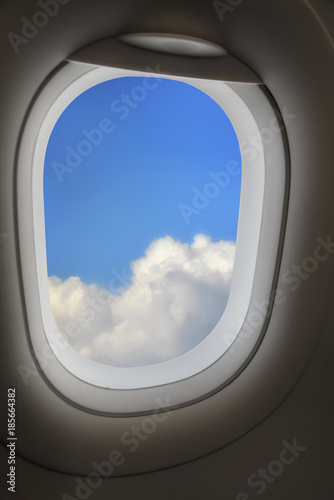 Above cloud and blue sky from airplane window