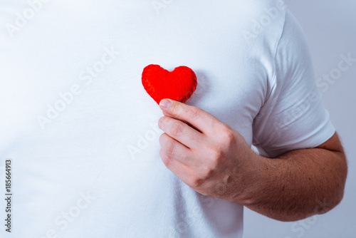 hand hold plush heart near chest