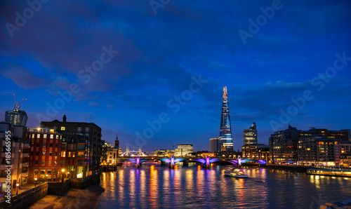 London cityscape with Southwark Bridge and Shard skyscraper at night