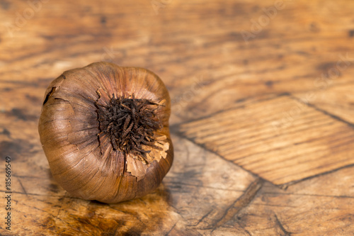Black garlic on an old wooden table