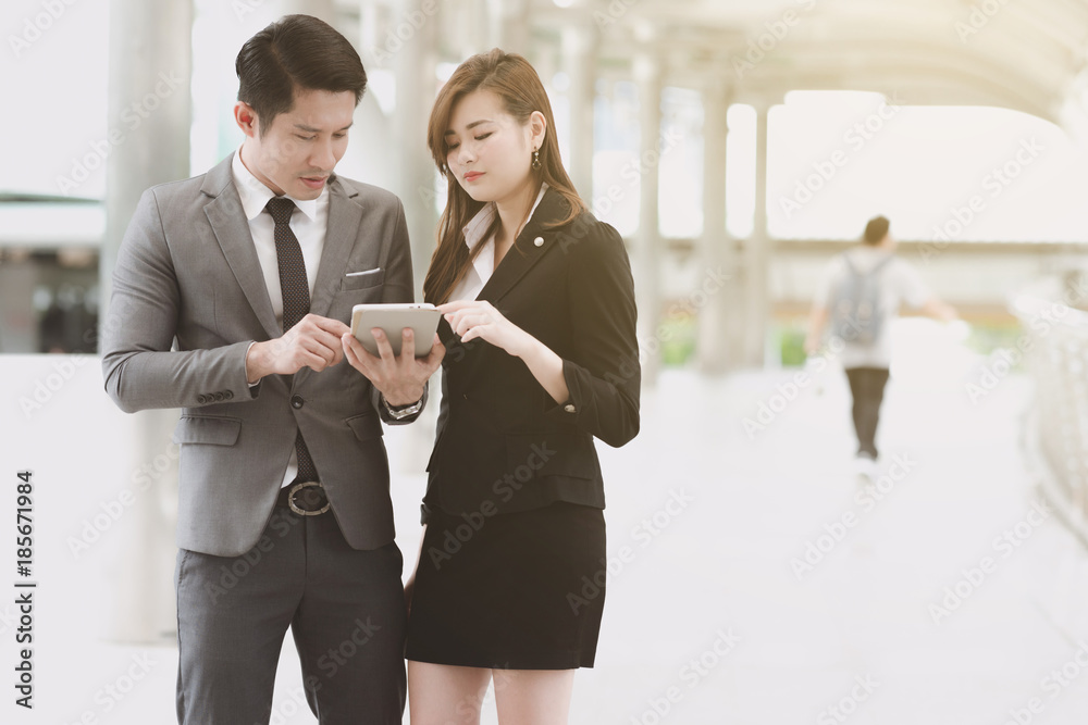 Fototapeta premium Young generation business team concept. Young business intern woman getting final coach by her male manager before going to meet client in office for the first time. Taking in business district.