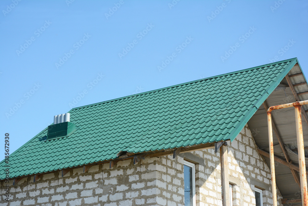 Damaged house metal roof sheets after hurricane to repair roof. Damaged house metal roof sheets after hurricane to repair roof.