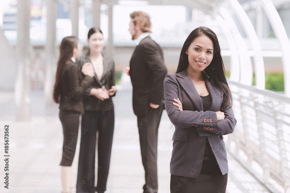 Confident looking mixed race business woman posing arm cross. Confident looking mixed race business woman posing arm cross.
