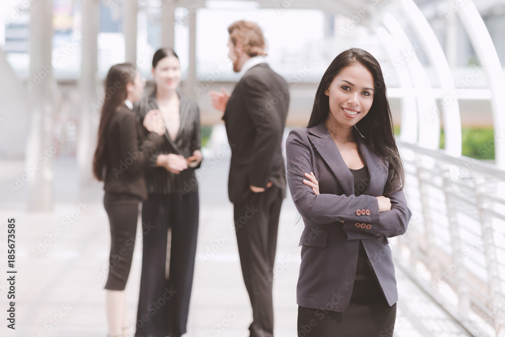 Confident looking mixed race business woman posing arm cross. Confident looking mixed race business woman posing arm cross.