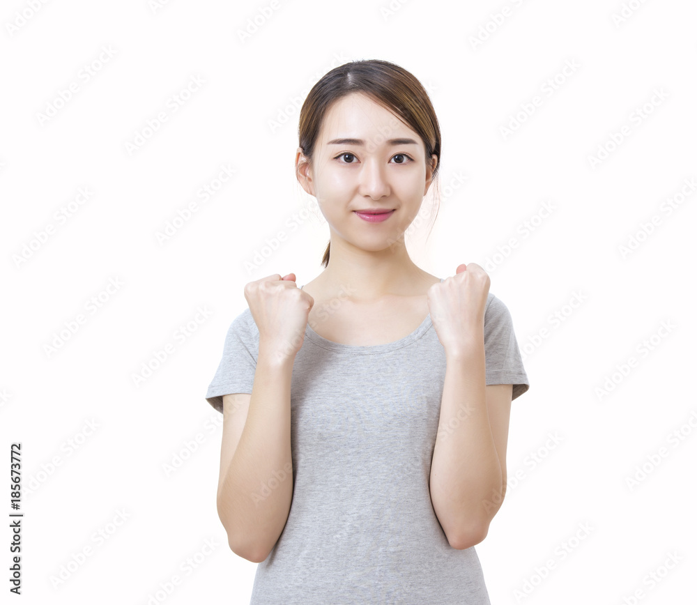 Young woman happily raised her fists up. Cheering isolated on white background. Young woman happily raised her fists up. Cheering isolated on white background.
