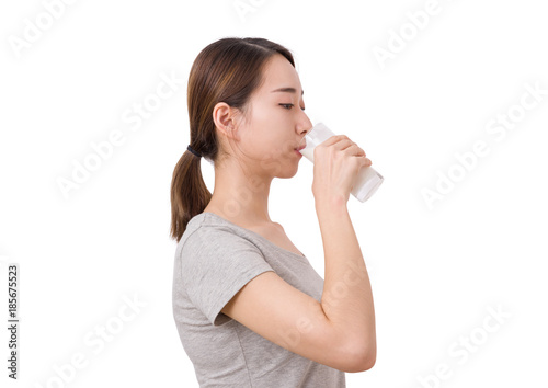 Woman drinking milk. Beautiful young woman enjoying a glass milk.