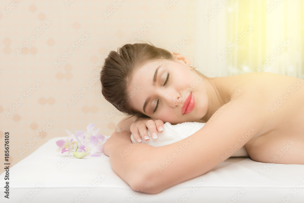 Asian exotic holiday spa concept. Beautiful young white woman enjoy relaxing during massage at spa, taken indoor in real spa location. Asian exotic holiday spa concept. Beautiful young white woman enjoy relaxing during massage at spa, taken indoor in real spa location.