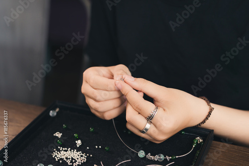 Female designer making jewelries at a jewelry shop o