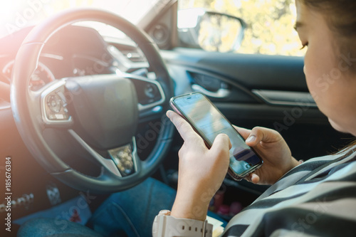 car interior background beauty young woman touch mobile phone and sit on seat inside car. image for vehicle, person, technology, drive concept